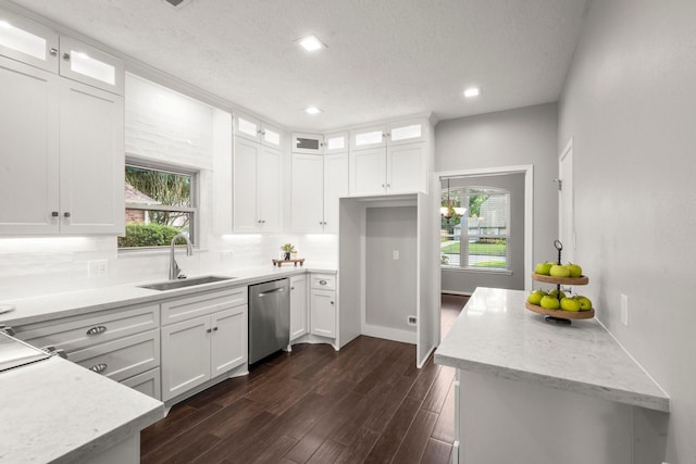 16907 Misty Creek Dr, Spring, TX 77379 - kitchen with stainless steel dishwasher, a sink, backsplash, white cabinetry, and recessed lighting
