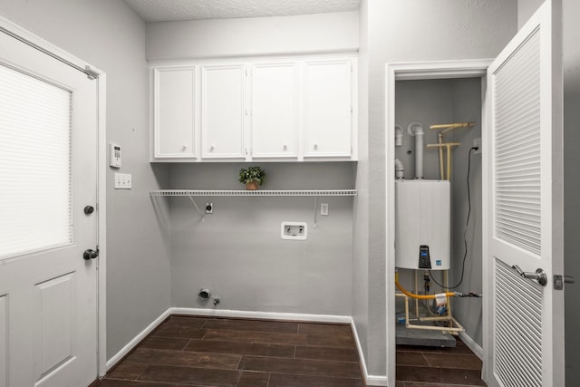 16907 Misty Creek Dr, Spring, TX 77379 - washroom with cabinet space, hookup for an electric dryer, dark wood-style flooring, water heater, and hookup for a washing machine