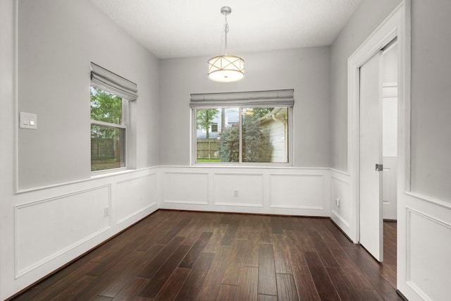16907 Misty Creek Dr, Spring, TX 77379 - unfurnished room with wainscoting, dark wood-style flooring, and a decorative wall