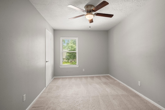 16907 Misty Creek Dr, Spring, TX 77379 - unfurnished room with a textured ceiling, light colored carpet, ceiling fan, and baseboards