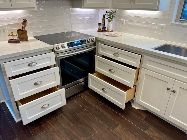 16907 Misty Creek Dr, Spring, TX 77379 - kitchen with stainless steel electric stove, white cabinetry, tasteful backsplash, light stone counters, and dark wood-style floors