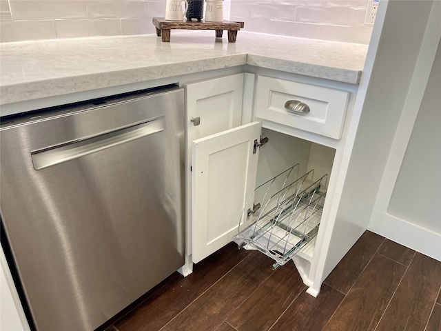 16907 Misty Creek Dr, Spring, TX 77379 - kitchen view of stainless steel dishwasher, dark wood-style floors, backsplash, and white cabinets