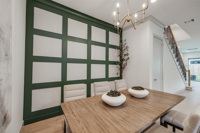 1724 Ridgewood St, Houston, TX 77006 - dining space featuring a chandelier, stairs, and light wood-style flooring