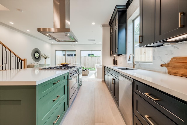 1724 Ridgewood St, Houston, TX 77006 - kitchen with appliances with stainless steel finishes, a sink, extractor fan, green cabinetry, and decorative backsplash