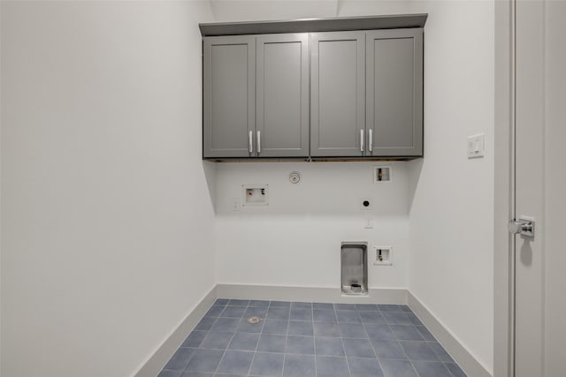 1724 Ridgewood St, Houston, TX 77006 - laundry area with hookup for an electric dryer, hookup for a gas dryer, washer hookup, dark tile patterned flooring, and baseboards