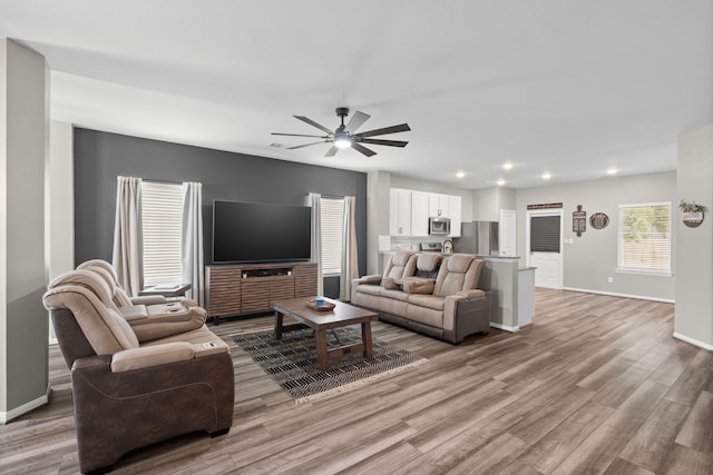 7315 Parkview Dr, Hitchcock, TX 77563 - living room featuring light wood-style flooring, ceiling fan, baseboards, and recessed lighting