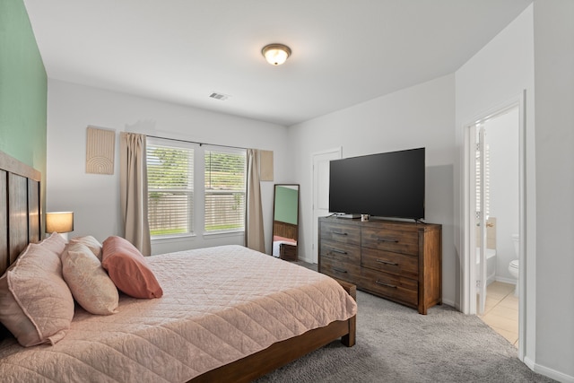 7315 Parkview Dr, Hitchcock, TX 77563 - bedroom with light colored carpet, baseboards, and ensuite bathroom