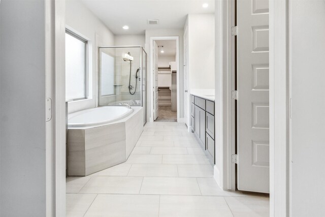 11439 Bush Clover Dr, Cypress, TX 77433 - full bath with a spacious closet, a shower stall, a garden tub, tile patterned flooring, and vanity