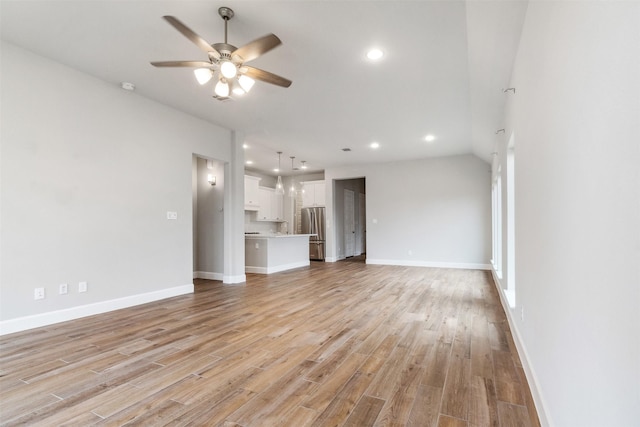 11439 Bush Clover Dr, Cypress, TX 77433 - unfurnished living room with a ceiling fan, recessed lighting, light wood-style flooring, and baseboards