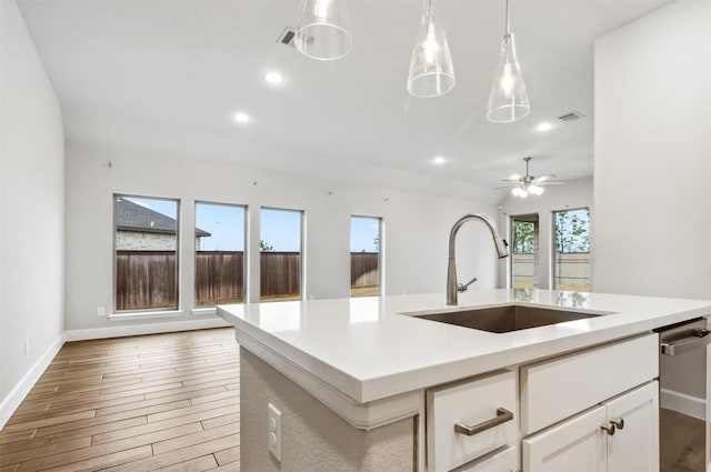 11439 Bush Clover Dr, Cypress, TX 77433 - kitchen featuring a sink, baseboards, light countertops, wood finished floors, and recessed lighting