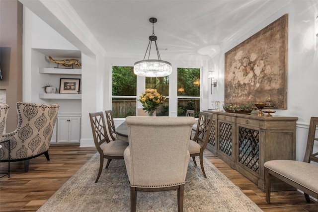 308 Lane Landing Pl, Montgomery, TX 77316 - dining space featuring wood finished floors, a chandelier, and crown molding