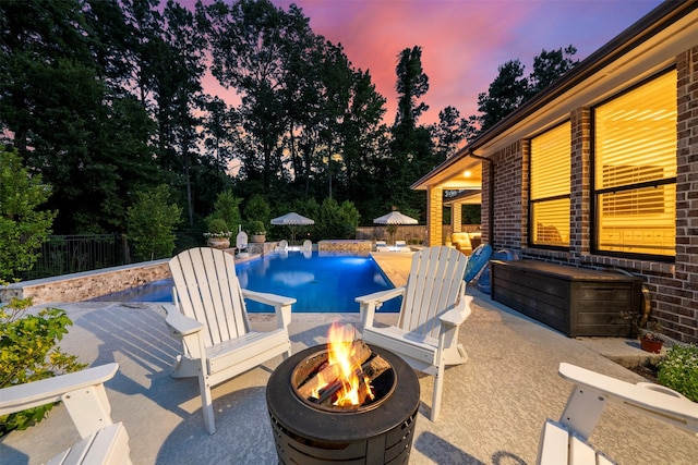 308 Lane Landing Pl, Montgomery, TX 77316 - swimming pool with a fire pit, a patio area, a fenced backyard, and view of scattered trees
