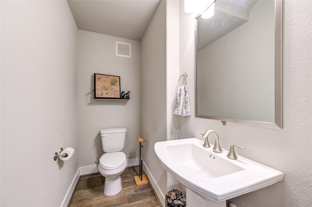 10918 Brookeshire Chase Ln, Houston, TX 77043 - bathroom featuring toilet, wood finished floors, and baseboards