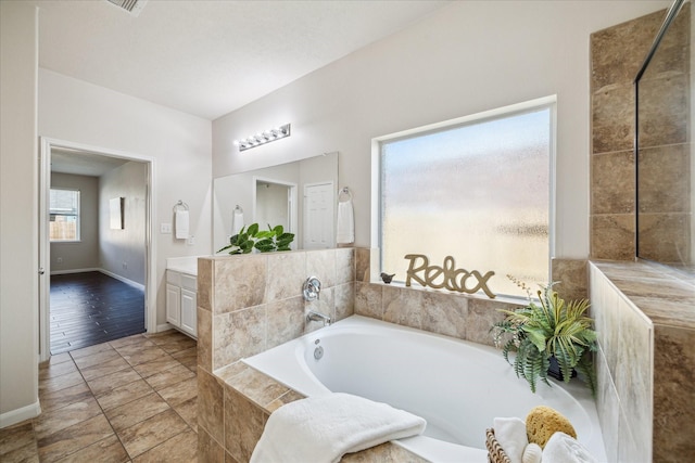13303 Bomoseen Lake Rd, Houston, TX 77044 - full bath featuring a garden tub, vanity, and baseboards