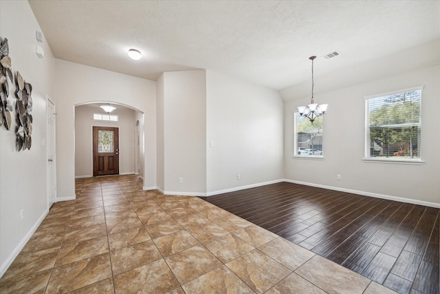 13303 Bomoseen Lake Rd, Houston, TX 77044 - foyer with arched walkways, plenty of natural light, a chandelier, and baseboards