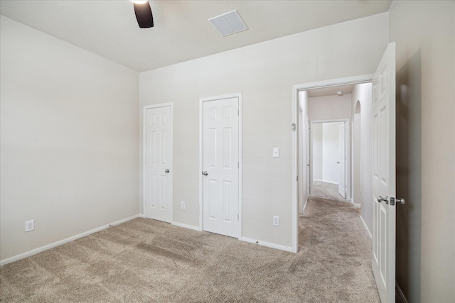 13303 Bomoseen Lake Rd, Houston, TX 77044 - unfurnished bedroom featuring carpet, baseboards, a ceiling fan, and two closets