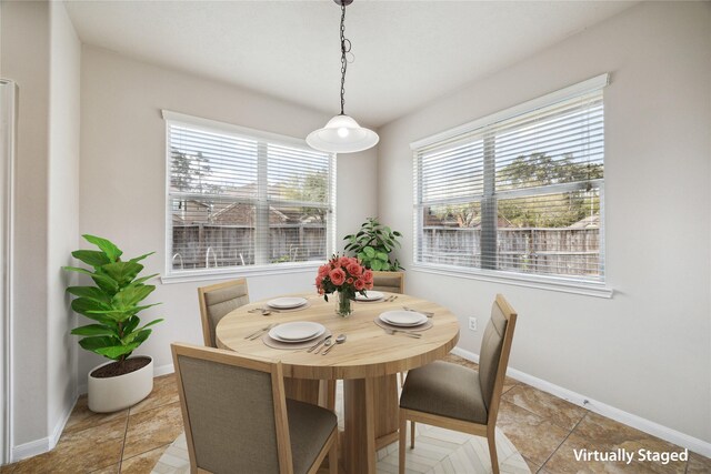 13303 Bomoseen Lake Rd, Houston, TX 77044 - dining area with baseboards and light tile patterned floors