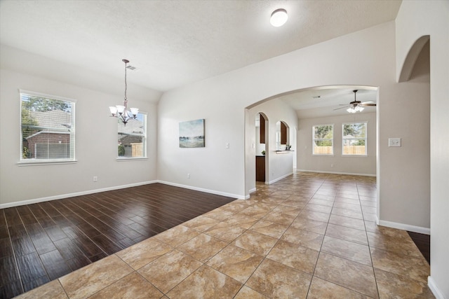 13303 Bomoseen Lake Rd, Houston, TX 77044 - empty room featuring arched walkways, a ceiling fan, a chandelier, and baseboards