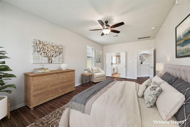 13303 Bomoseen Lake Rd, Houston, TX 77044 - bedroom with dark wood-style flooring, baseboards, ensuite bath, and a ceiling fan