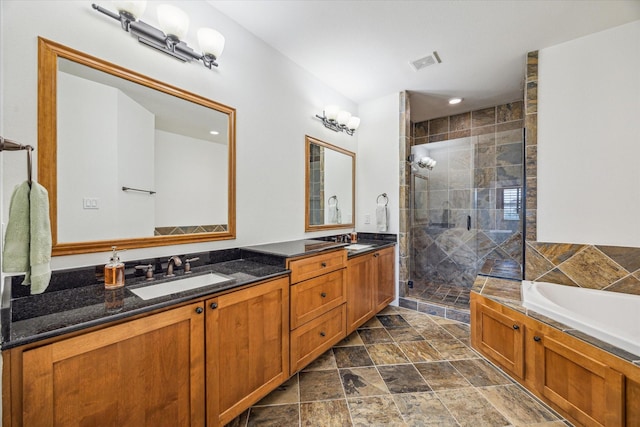6110 Clyde St, Houston, TX 77007 - bathroom featuring double vanity, a stall shower, a bath, and stone finish floors