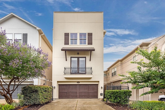 6110 Clyde St, Houston, TX 77007 - view of front facade featuring a balcony, an attached garage, driveway, and stucco siding