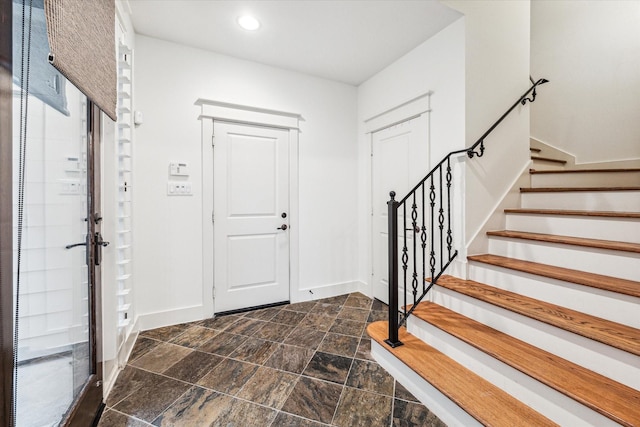 6110 Clyde St, Houston, TX 77007 - entryway with dark stone finish flooring, baseboards, stairway, and recessed lighting