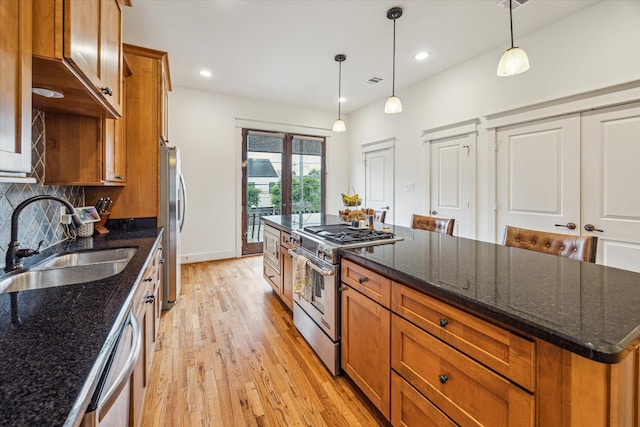 6110 Clyde St, Houston, TX 77007 - kitchen featuring appliances with stainless steel finishes, a sink, brown cabinetry, and recessed lighting