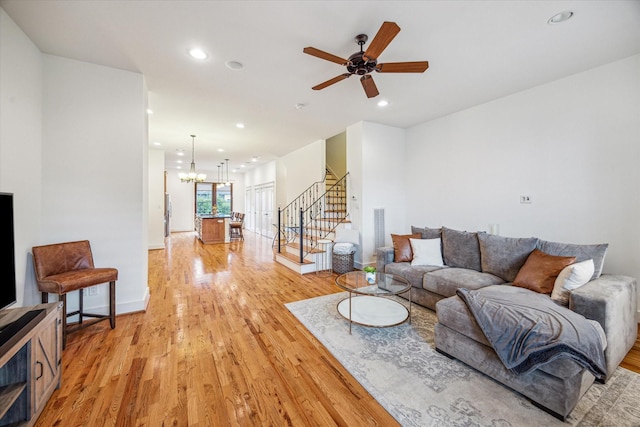6110 Clyde St, Houston, TX 77007 - living room featuring light wood-style flooring, stairs, a chandelier, recessed lighting, and a ceiling fan
