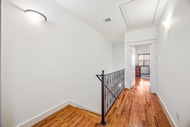 6110 Clyde St, Houston, TX 77007 - hall featuring attic access, an upstairs landing, light wood finished floors, and baseboards