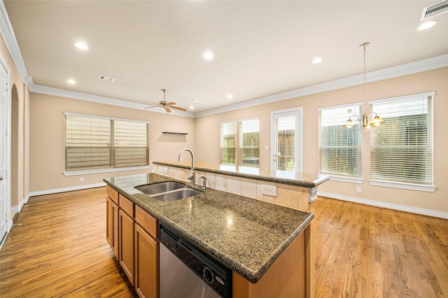 2804 Sherwin St, Houston, TX 77007 - kitchen with dishwasher, a sink, a center island with sink, ornamental molding, and brown cabinets