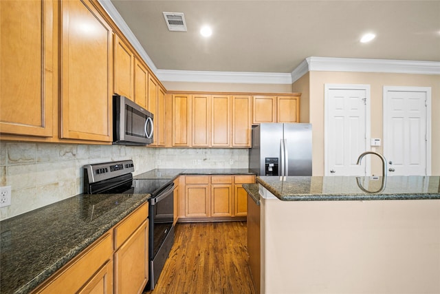 2804 Sherwin St, Houston, TX 77007 - kitchen with stainless steel appliances, crown molding, dark wood-type flooring, backsplash, and dark stone counters