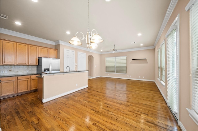 2804 Sherwin St, Houston, TX 77007 - kitchen with stainless steel fridge, a ceiling fan, tasteful backsplash, recessed lighting, and wood finished floors