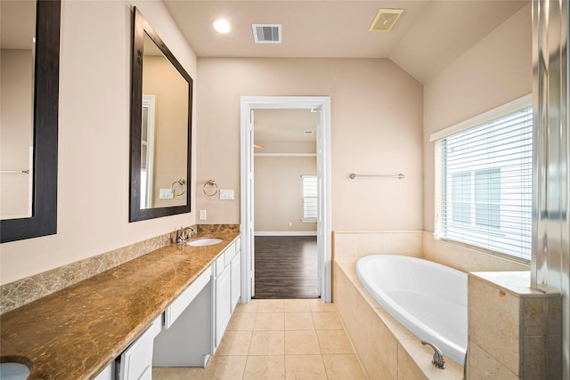 2804 Sherwin St, Houston, TX 77007 - bathroom with double vanity, a bath, tile patterned flooring, and vaulted ceiling