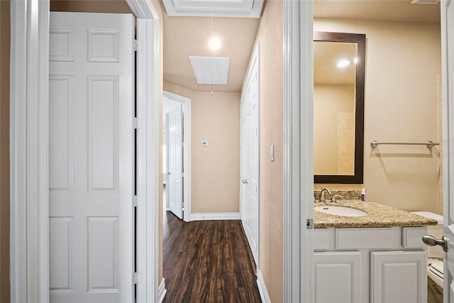 2804 Sherwin St, Houston, TX 77007 - hall featuring a sink, attic access, dark wood-style floors, and baseboards