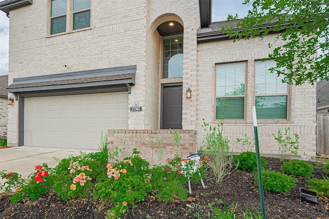 21307 Metallic Blue Dr, Cypress, TX 77433 - property entrance featuring brick siding, an attached garage, and concrete driveway