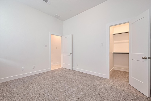 21307 Metallic Blue Dr, Cypress, TX 77433 - unfurnished bedroom featuring carpet flooring, a walk in closet, and baseboards