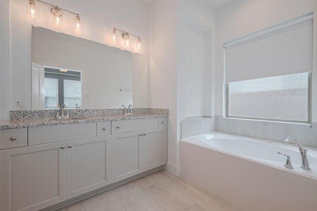 21307 Metallic Blue Dr, Cypress, TX 77433 - bathroom with double vanity and a bath