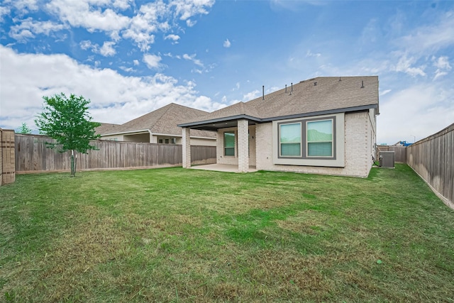 21307 Metallic Blue Dr, Cypress, TX 77433 - back of house featuring central AC, a patio area, roof with shingles, and brick siding