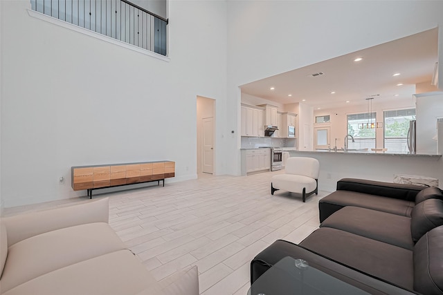 21307 Metallic Blue Dr, Cypress, TX 77433 - living area with a high ceiling, baseboards, and recessed lighting