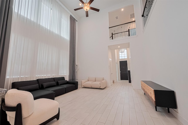 21307 Metallic Blue Dr, Cypress, TX 77433 - living room featuring a towering ceiling, ceiling fan, and light wood finished floors