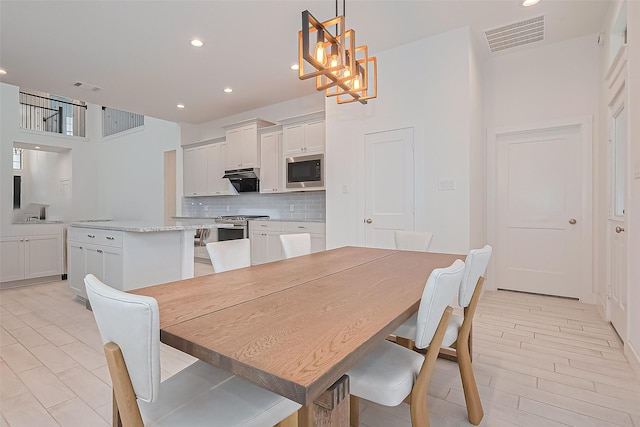 21307 Metallic Blue Dr, Cypress, TX 77433 - dining space featuring a chandelier, recessed lighting, and a towering ceiling