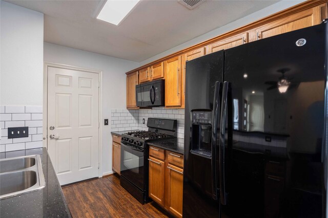 1405 Saulnier St, Houston, TX 77019 - kitchen featuring black appliances, tasteful backsplash, dark wood finished floors, and brown cabinets