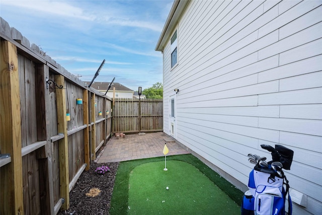 1405 Saulnier St, Houston, TX 77019 - fenced backyard with an area to practice putting and a patio