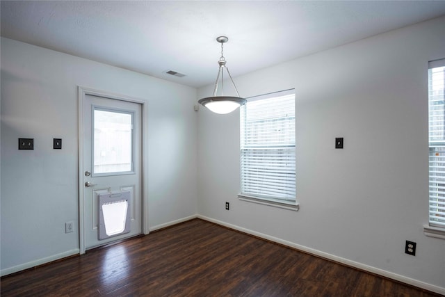 1405 Saulnier St, Houston, TX 77019 - unfurnished dining area with dark wood-style flooring and baseboards