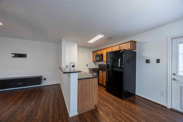 1405 Saulnier St, Houston, TX 77019 - kitchen with black appliances, dark countertops, dark wood finished floors, and tasteful backsplash