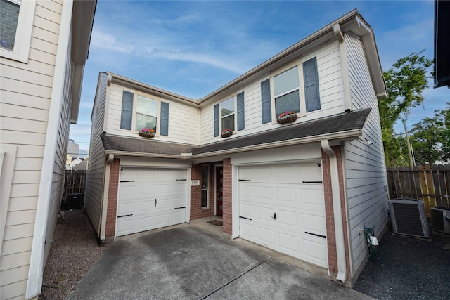1405 Saulnier St, Houston, TX 77019 - traditional home featuring a garage, brick siding, and concrete driveway