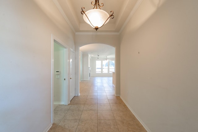 5226 Englewood Point Ct, Katy, TX 77494 - corridor featuring arched walkways, a tray ceiling, crown molding, baseboards, and light tile patterned floors