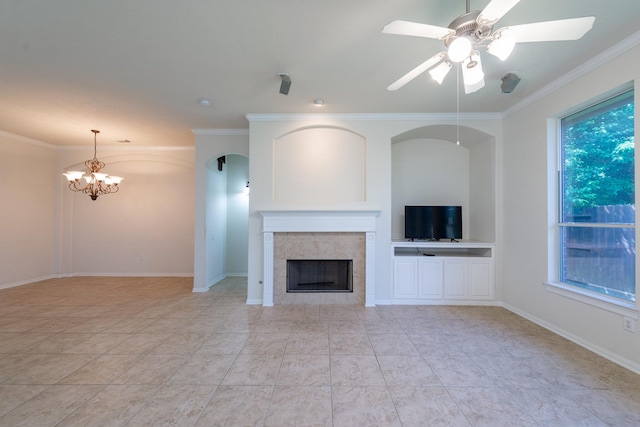 5226 Englewood Point Ct, Katy, TX 77494 - unfurnished living room featuring ornamental molding, a tiled fireplace, a chandelier, ceiling fan, and baseboards