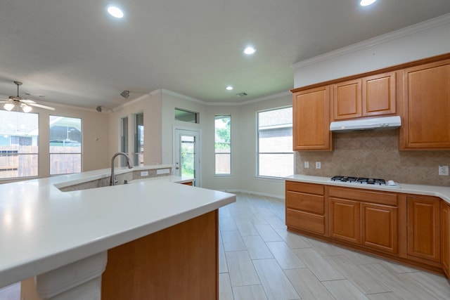 5226 Englewood Point Ct, Katy, TX 77494 - kitchen with under cabinet range hood, white gas cooktop, light countertops, recessed lighting, and tasteful backsplash