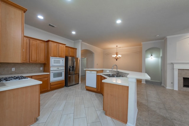 5226 Englewood Point Ct, Katy, TX 77494 - kitchen with white appliances, arched walkways, a sink, ornamental molding, and an island with sink